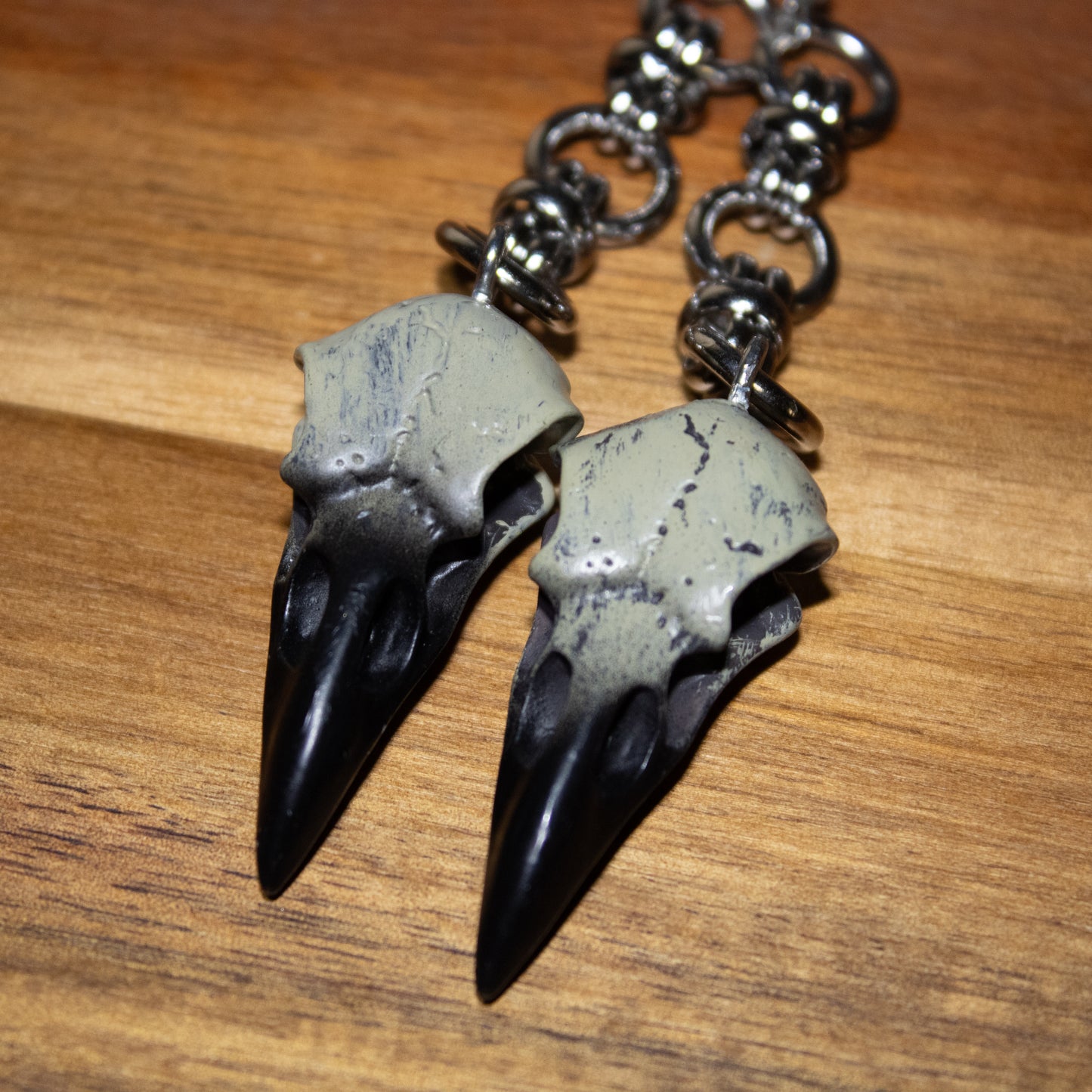 Carrion Call – Two-Tone Raven Skull Dangle Earrings